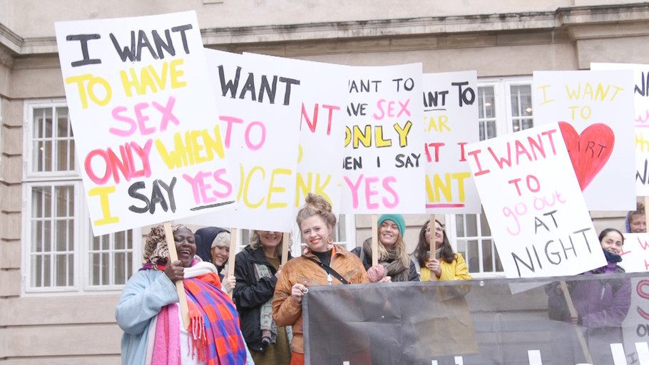 People at a protest, holding signs reading "I want to have sex only when I say yes", "I want to go out at night", and other similar signs that are not fully visible.