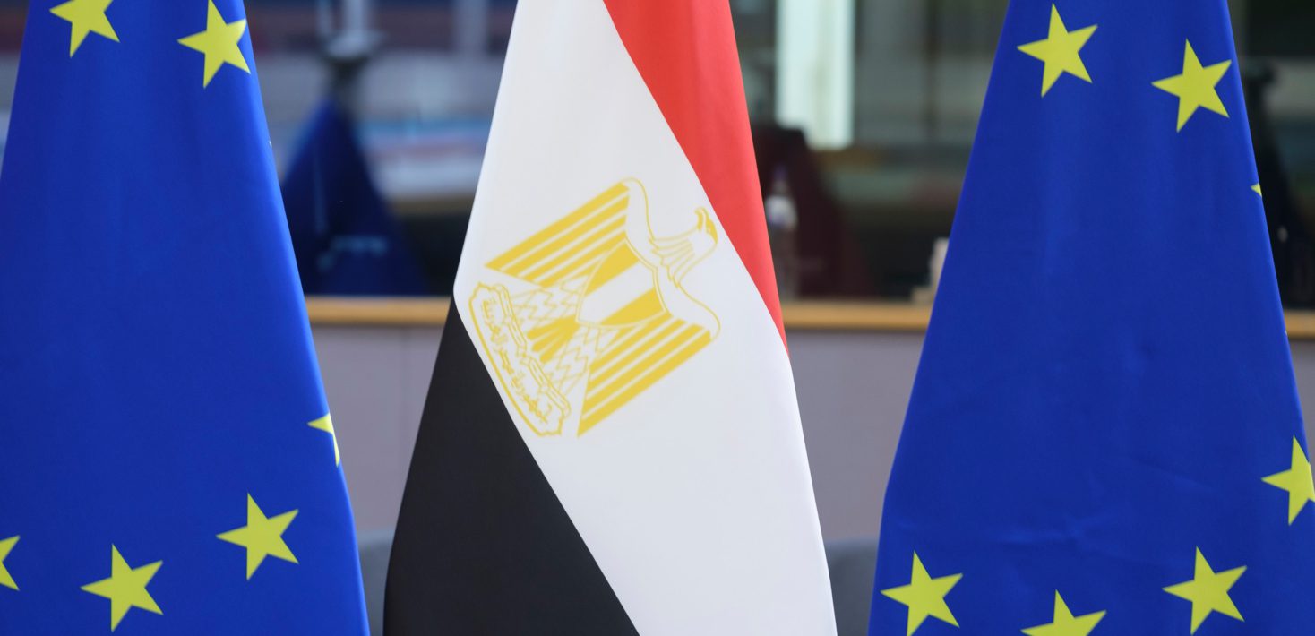 An Egyptian flag is visible between two flags of the European Union.